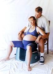 Photo of woman sitting on Seat and leaning back against partner seated behind her